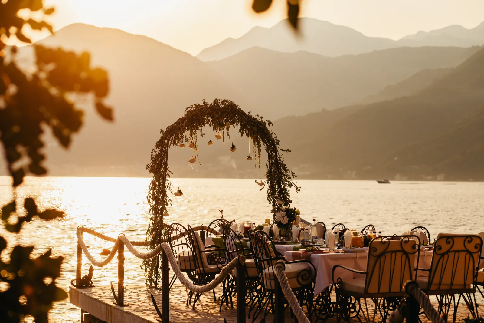 Wedding arch by a lake in a sunny Mediterranean country for a wedding after getting a Certificate of No Impediment to get married abroad.